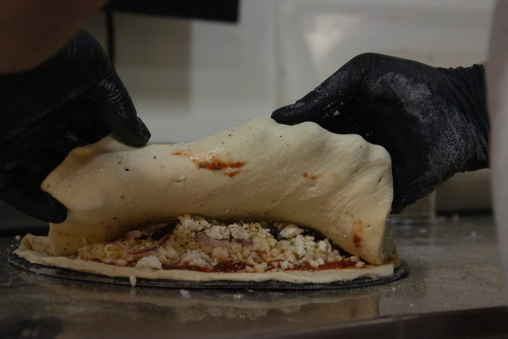 Person making a pizza
